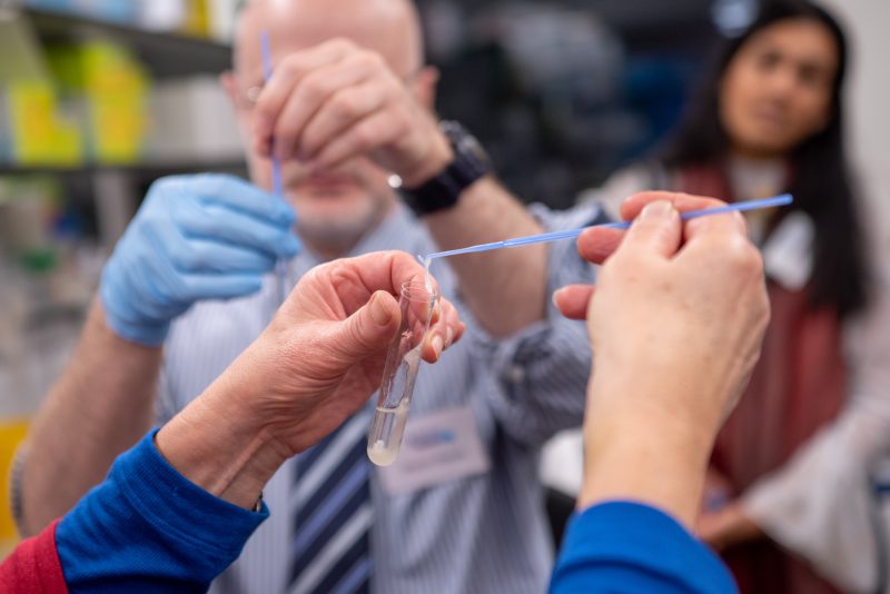 Guided by Dr Williamson, our fundraisers have a go at a hands-on experiment.